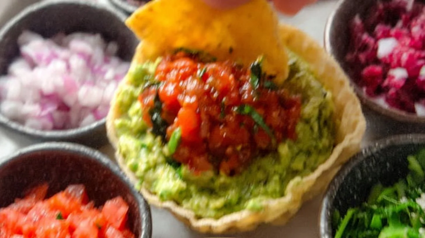 Delicious bowl of best guacamole with fresh ingredients